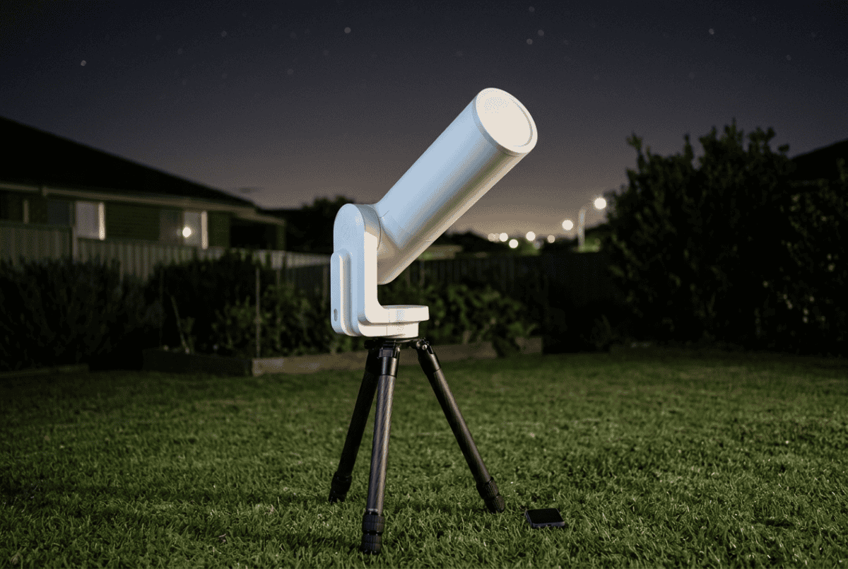 Unistellar eQuinox 2 smart telescope with its smooth white body and single-arm mount in a backyard at night